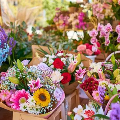 closeup-of-colorful-flower-bouquets-in-containers-at-an-outdoor-shop.jpg